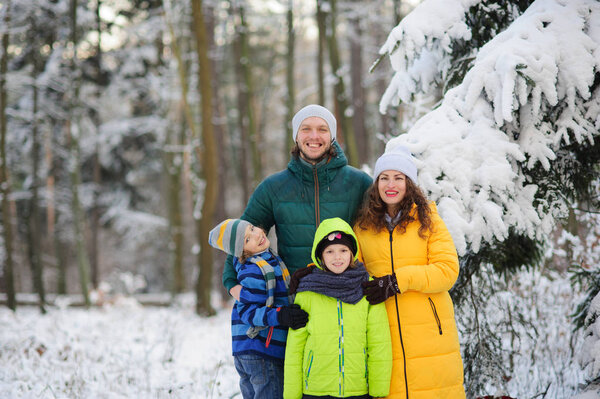 Family portrait in the winter forest.