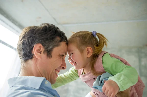 Father holds the little daughter on hands. — Stock Photo, Image