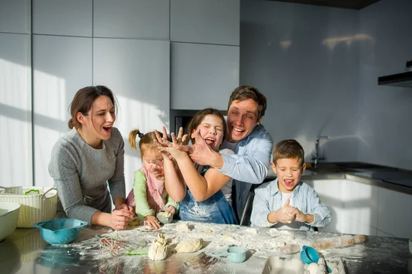 Large family prepares something of dough. — Stock Photo, Image