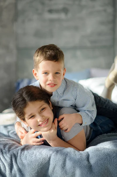Two Children Boy Girl Lie Bed Younger Brother Embraces Elder — Stock Photo, Image