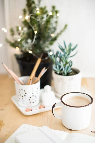 Горщик гарячого зимового напою на столі з деталями домашнього офісу — стокове фото