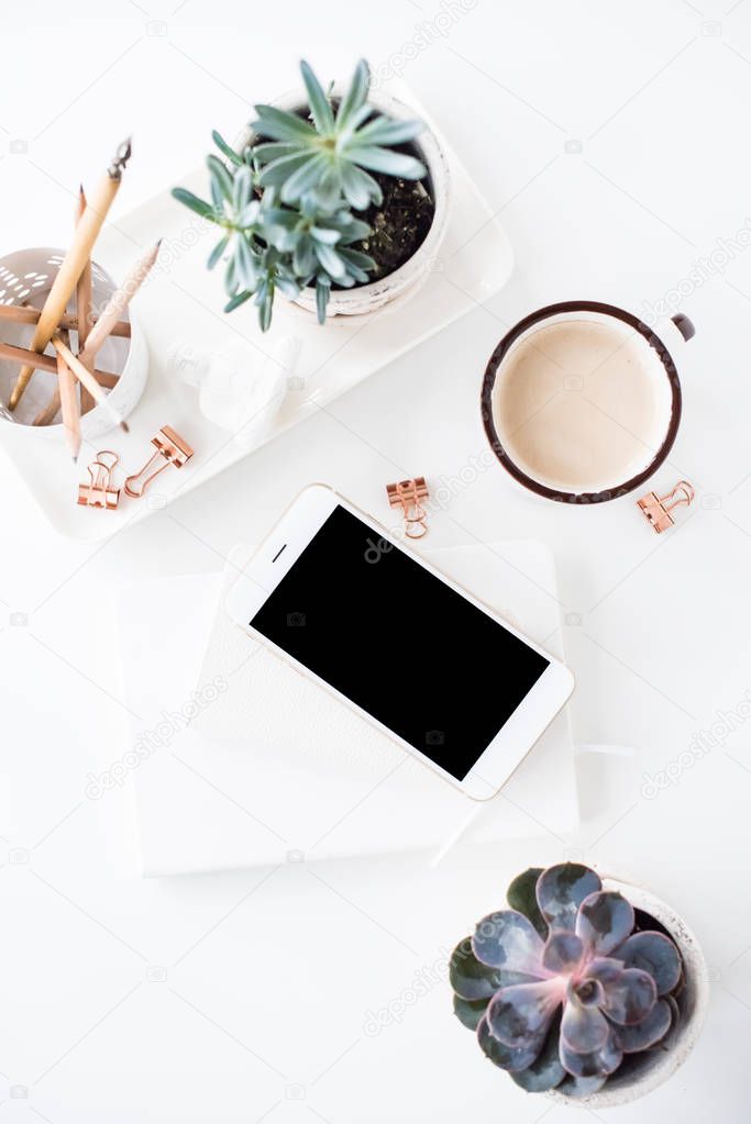 office desk flat lay with coffe, smartphone and succulents, clea