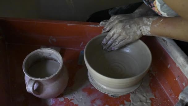 Frauenhände stellen Keramikschalen aus Ton her, arbeiten in einer Töpferei — Stockvideo