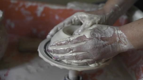 As mãos de mulheres fazem o boliche cerâmico do barro, trabalho em uma oficina de cerâmica — Vídeo de Stock