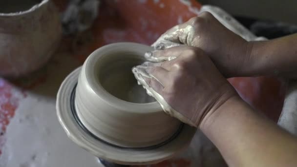 Womens hands make ceramic bowl from clay, work in a pottery workshop — Stock Video