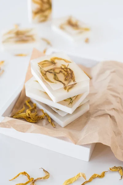 White handmade soap bars with yellow sunflower petals — Stock Photo, Image