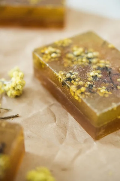 Brown and yellow handmade soap bars with honey and herbs — Stock Photo, Image