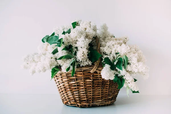 Bukett färsk vit lila blommor i korg på trä — Stockfoto