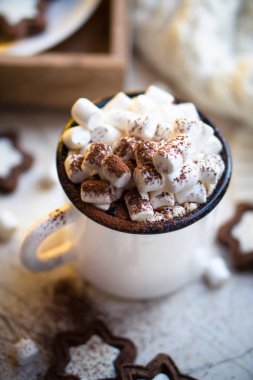 Rahatlatıcı Noel yemeği, bir kupa kremalı sıcak kakao ve sıcak ışıklı kurabiyeler.