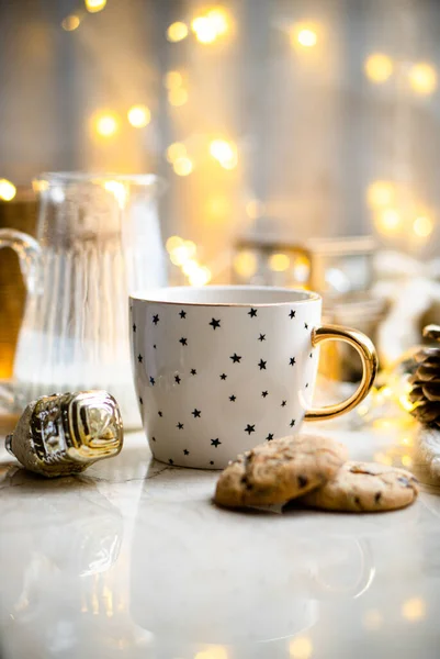 Cozy winter holiday decoration, Christmas lights and coffee cup with decor details, real home — Stock Photo, Image