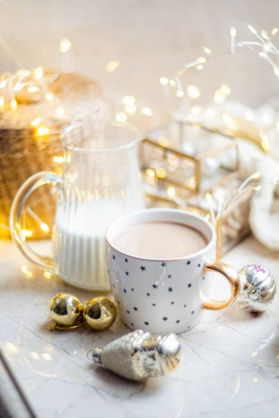 Cozy winter holiday decoration, Christmas lights and coffee cup with decor details, real home — Stock Photo, Image
