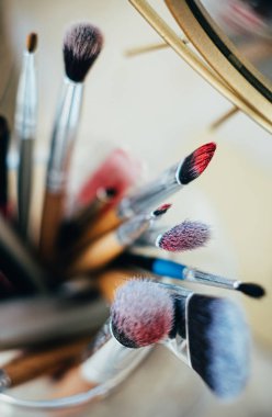 Many different makeup brushes in artists studio