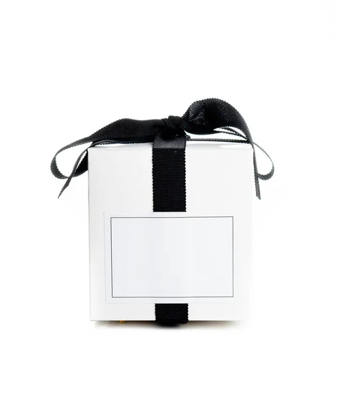 White gift box with empty lable and black satin ribbon isolated on white background, stylish holiday present — Stock Photo, Image