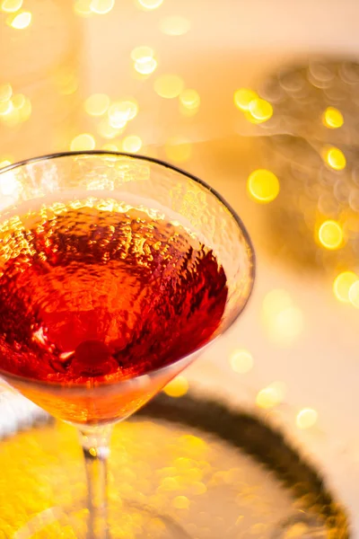 Classic red cocktail in fancy texture glass on bright light bokeh background — Stock Photo, Image
