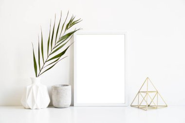 White frame and home decoration details on tabletop with wall, artwork poster mock-up