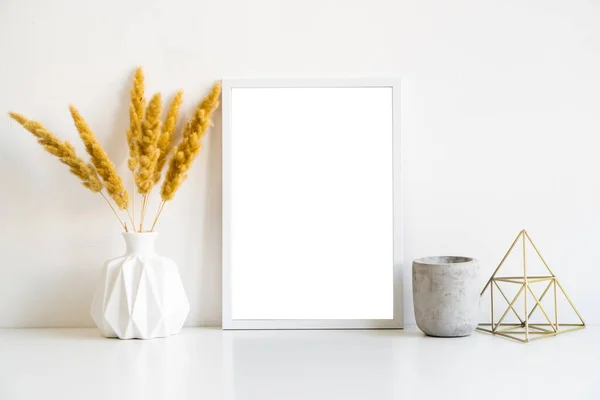White frame and home decoration details on tabletop with wall, artwork poster mock-up — Stockfoto