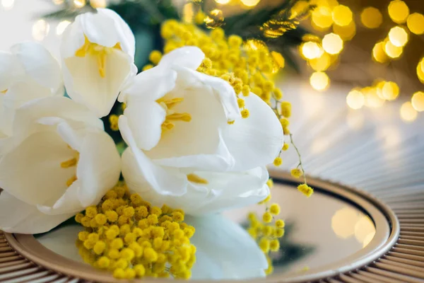 Boeket witte tulpen en mimosa bloemen op spiegelblad — Stockfoto