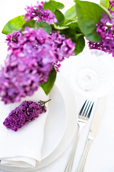 Ajuste de mesa de primavera con rama lila en servilleta de lino blanco — Foto de Stock