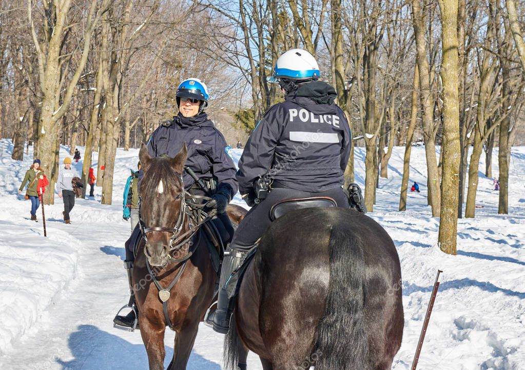 MONTREAL, CANADA - FEBRUARY 2, 2017: - Montreal Mounted Patrol officers in Mont-Royal park.