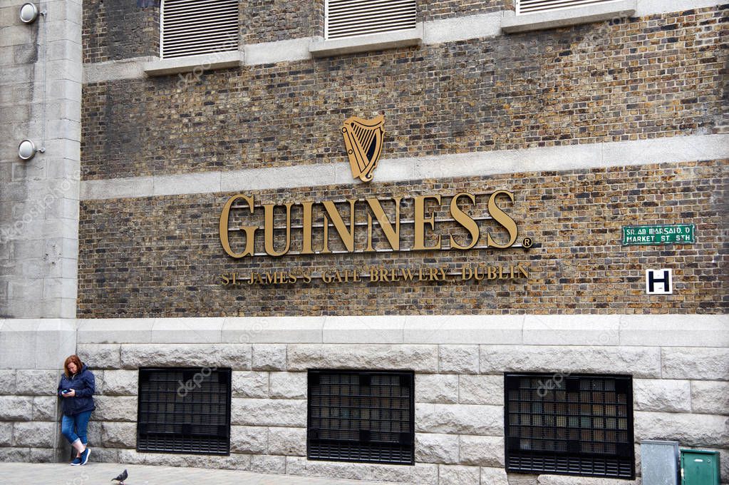 DUBLIN, IRELAND - AUGUST 3, 2017 : Guinness logo on its Storehouse in Dublin. Guinness Storehouse is a tourist attraction at St. James's Gate Brewery in Dublin, Ireland.