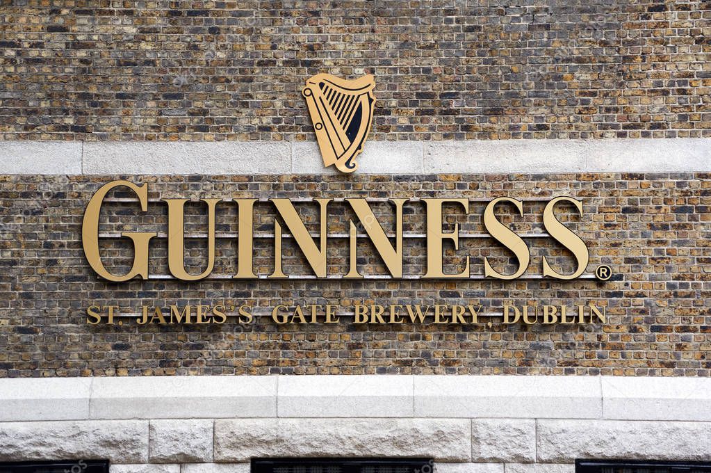 DUBLIN, IRELAND - AUGUST 3, 2017 : Guinness logo on its Storehouse in Dublin. Guinness Storehouse is a tourist attraction at St. James's Gate Brewery in Dublin, Ireland.