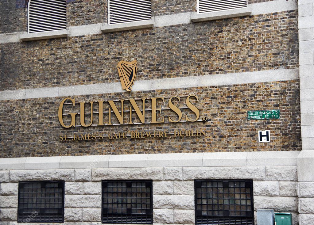 DUBLIN, IRELAND - AUGUST 3, 2017 : Guinness logo on its Storehouse in Dublin. Guinness Storehouse is a tourist attraction at St. James's Gate Brewery in Dublin, Ireland.