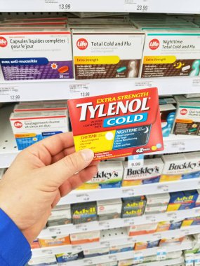 Montreal, Kanada - 10 Mart 2018: Tylenol paketi tutan bir el. Tylenol ilaçlar ağrıyı, ateş azaltılması ve alerji, soğuk, baş ağrısı belirtileri rahatlatma için reklamı bir markasıdır.