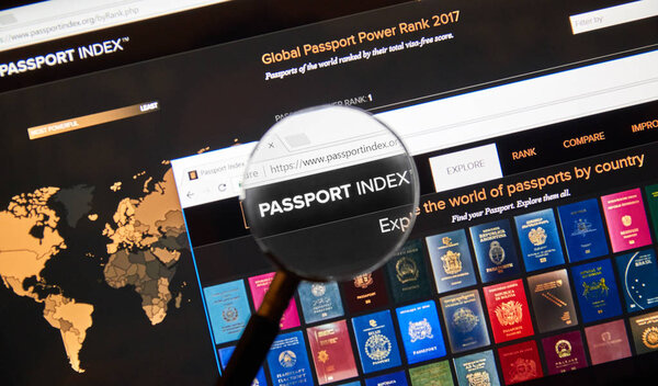 Passport index web page under magnifying glass.