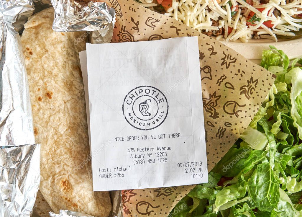 Montreal, Canada - September 7, 2019: Chipotle plate and receipt with salad. Chipotle, is an American chain of fast casual restaurants specializing in tacos and Mission-style burritos