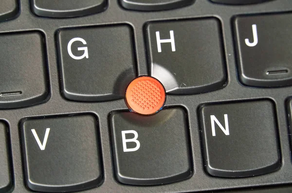 Red trackpoint on a laptop keyboard. A pointing stick is a small joystick used as a pointing device typically mounted centrally in a computer keyboard.