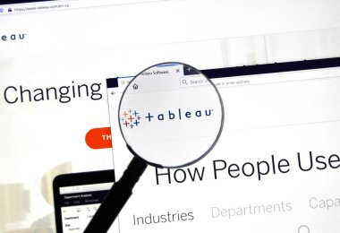 Montreal, Canada - March 08, 2020: Tableau official web site and logo under magnifying glass. Tableau Software is an American interactive data visualization software company clipart