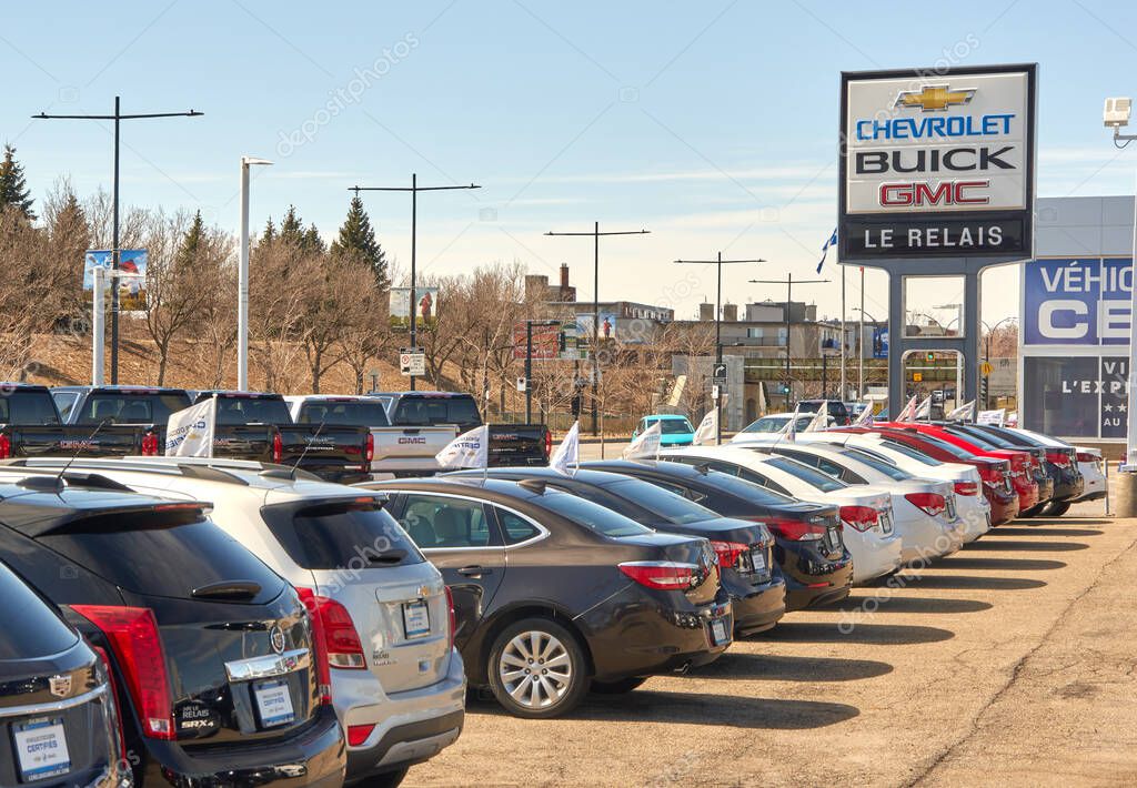 Montreal, Canada - April 4, 2020: Chevrolet Buick and GMC dealership with parking and cars on sunny day. They are most popular and recognizable automotive brands in the US.