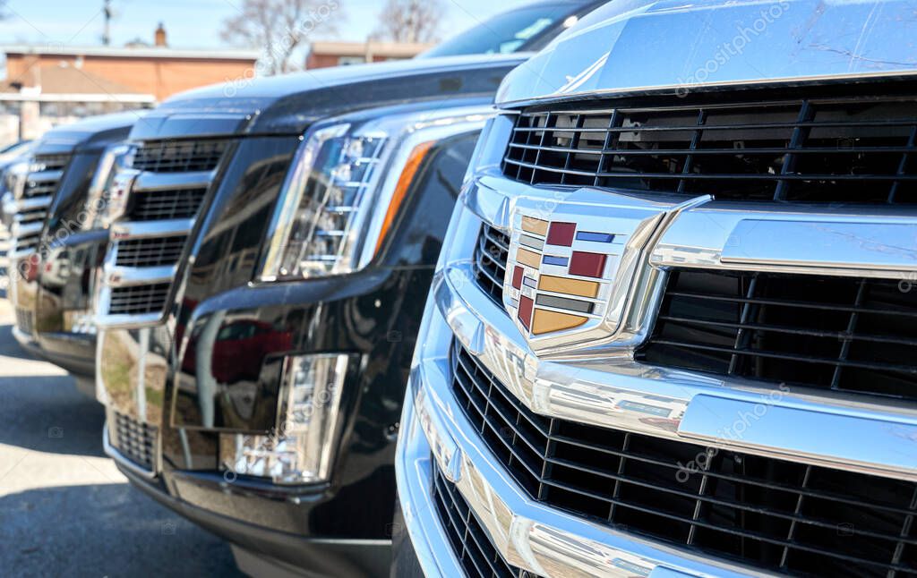 Montreal, Canada - April 4, 2020: Cadillac Escalade black car at dealership. Cadillac is a division of American automobile manufacturer General Motors GM that designs and builds luxury vehicles.