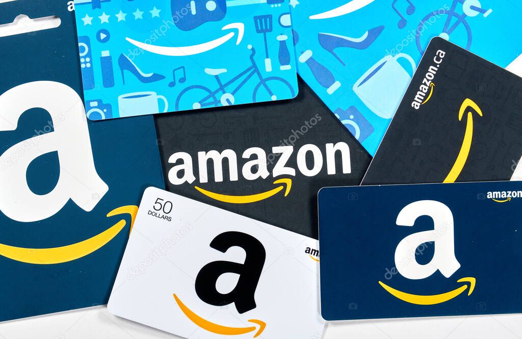 Montreal, Canada - April 6, 2020: Different Amazon gift cards. Amazon is a titan of e-commerce, payments, hardware, data storage, cloud computing, and media. It is founded and run by Jeff Bezos