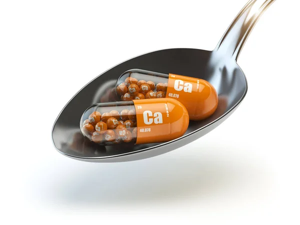 スプーンでカルチョ カルシウム Ca 要素を持つ錠剤。食事 suppl — ストック写真