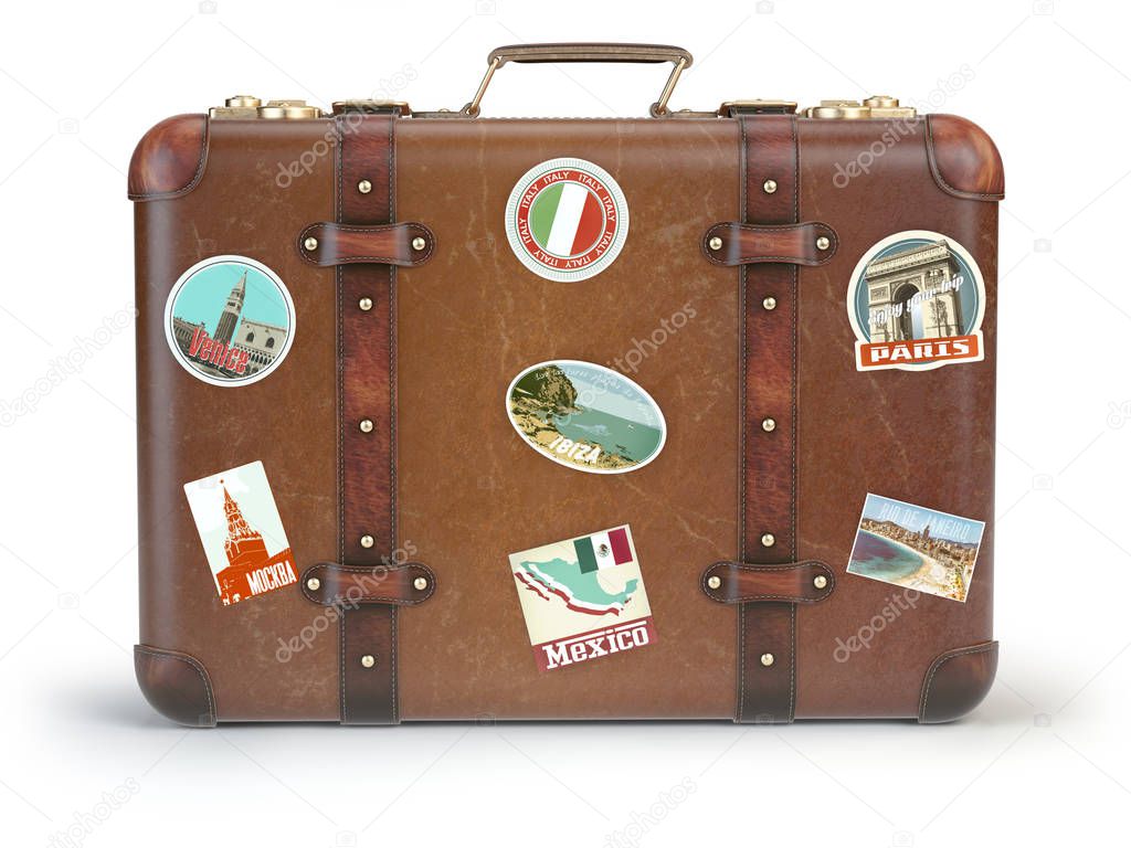 Vintage suitcase with travel stickers isolated on white backgrou