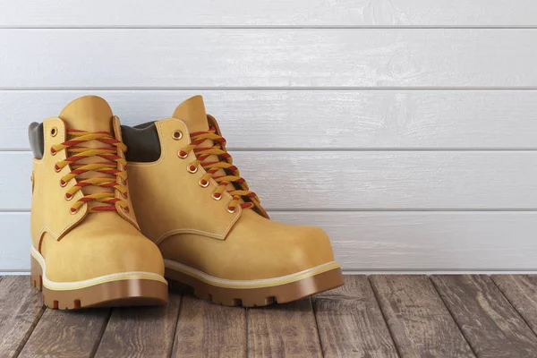 Bottes jaunes sur une table en bois — Photo