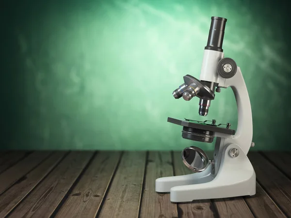 Microscope on wooden table and green vintage background — Stock Photo, Image