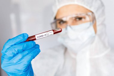 Covid 19 Coronavirus, Coronavirus araştırma laboratuarındaki bilim kadını doktor biyolojik tehlike koruma giysileri elinde bulunan tüpteki kanı enfekte etti. Coronavirus Covid-19 aşı araştırması
