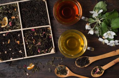 various types of tea on a wooden background