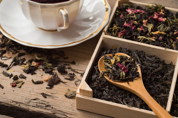 Various types of tea on a wooden background — Stok fotoğraf