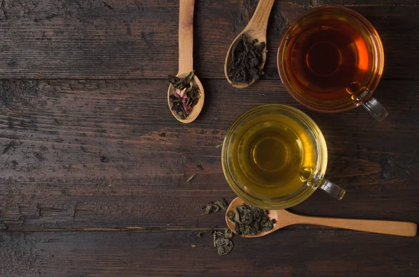 Various types of tea on a wooden background — Stok fotoğraf
