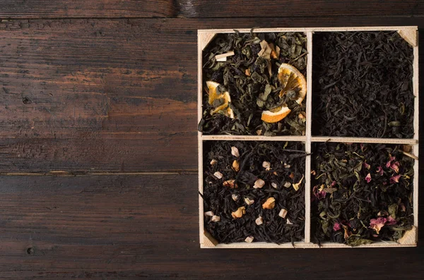 Various types of tea on a wooden background — Stok fotoğraf