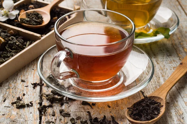 Various types of tea on a wooden background — Stok fotoğraf