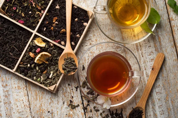 Různé druhy čaje na dřevěném pozadí — Stock fotografie