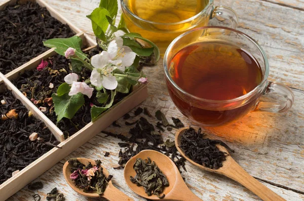 Various types of tea on a wooden background — Stok fotoğraf