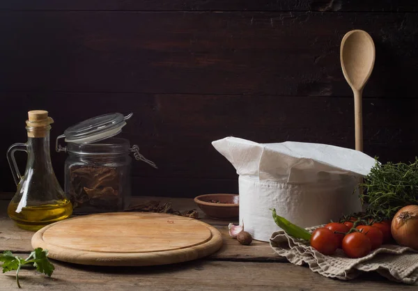 Sombrero de chef en una vieja mesa de madera. Antecedentes conceptuales sobre la —  Fotos de Stock