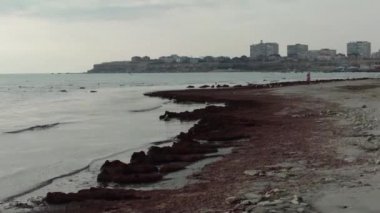 City on the shore of the Caspian Sea. Kazakhstan. Aktau. Mangistau region. 26 January 2020 year. Pink algae in the Caspian Sea.
