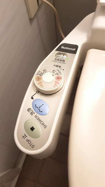 Tokyo, Japan - April 12, 2019: High tech toilet controller with electronic bidet in Japan. The feature set commonly found on washlets are anal hygiene, bidet washing, seat warming, and deodorization.