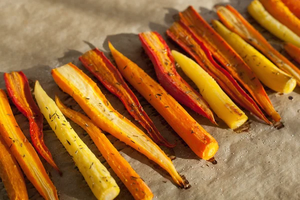 Roasted colorful carrots on baking sheet — Stock Photo, Image